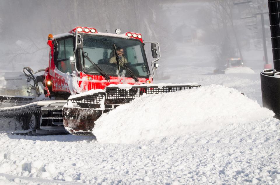 Snow Cats are seen pushing snow at Snow Trails this winter.