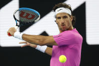 Feliciano Lopez of Spain plays a backhand return to John Millman of Australia during their first round match at the Australian Open tennis championships in Melbourne, Australia, Monday, Jan. 17, 2022. (AP Photo/Hamish Blair)