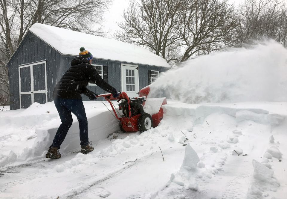 Ben Jennings snowblows his driveway on Sunday, Jan. 20, in Glenville, N.Y., where 16 inches of snow fell from Saturday evening through noon Sunday.