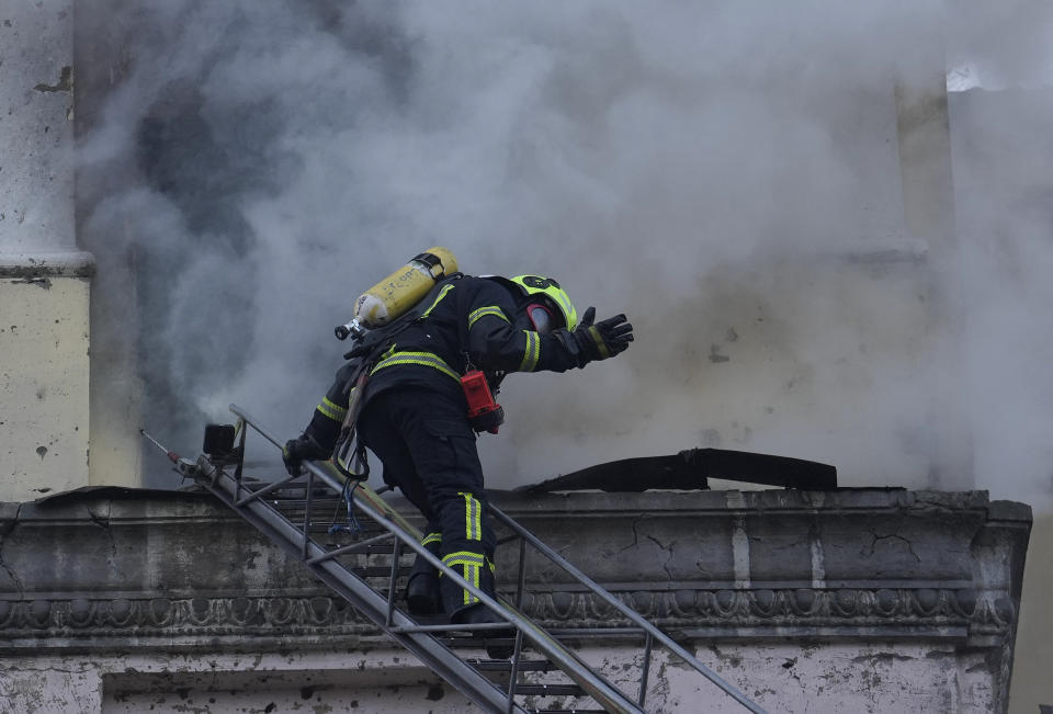 A firefighter gestures as he prepares to enter a building at the site after a Russian attack in Kyiv, Ukraine, Thursday, March 21, 2024. Around 30 cruise and ballistic missiles were shot down over Kyiv on Thursday morning, said Serhii Popko, the head of Kyiv City Administration. The missiles were entering Kyiv simultaneously from various directions in a first missile attack on the capital in 44 days. (AP Photo/Vadim Ghirda)