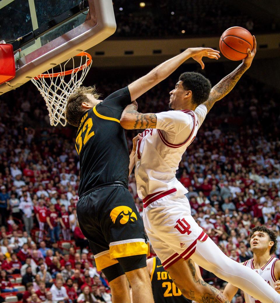 Indiana's Kel'el Ware (1) dunks over Iowa's Owen Freeman (32) as he is fouled during the second half of the Indiana versus Iowa men's basketball game at Simon Skjodt Assembly Hall on Tuesday, Jan. 30, 2024.