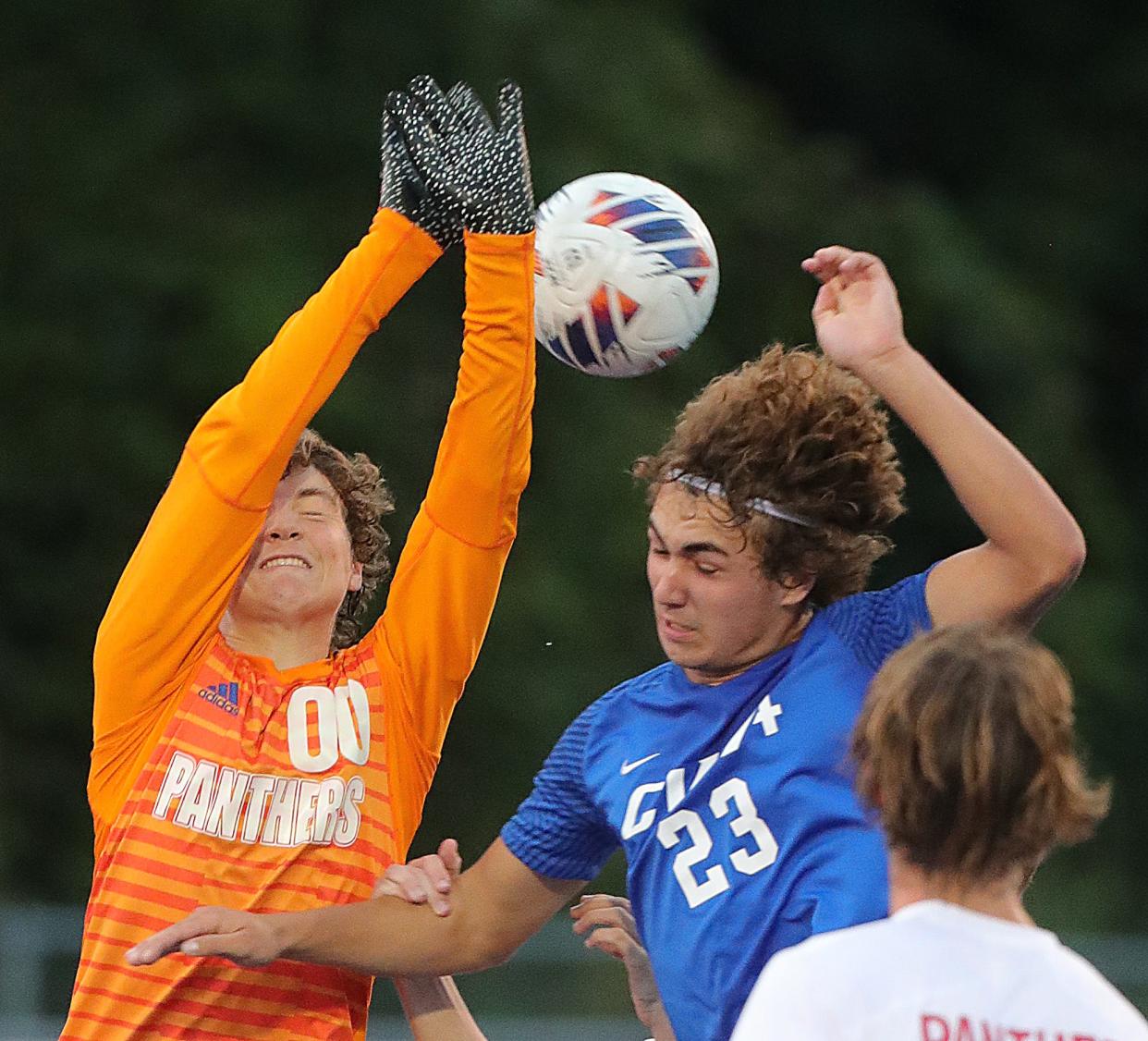 Norton keeper Ryan Schnering goes up to deflect a corner kick as CVCA's Griffin Bosshard moves in to go for the ball on Thursday, Sept. 15, 2022 in Cuyahoga Falls. CVCA won the match 5-1.