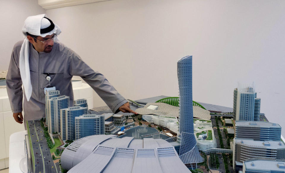 In this Wednesday, Dec. 11, 2013 photo, Nidal Abdulrahman Taiba, vice president for Development at the Jiddah Development and Urban Regeneration Company, points at a model for the Red Coast city’s new urban center project called Heart of Jeddah in Jiddah, Saudi Arabia. The municipality-owned company hopes the city center will include the country’s first movie theater, which would show documentaries only, and a metro that leads to a high-speed rail that connects Muslim pilgrims to the holy cities of Mecca and Medina. The new city center would also include 25,000 new residential units, a convention center, hotels and a dancing water fountain. The first phase of construction is to be finished by 2016. (AP Photo/Aya Batrawy)