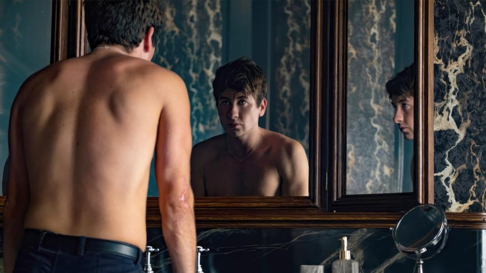 Oliver looks in the mirror in a scene from "Saltburn"