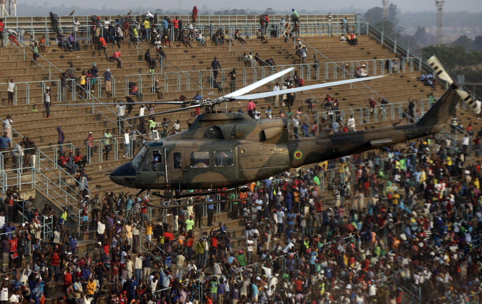 A helicopter transports the coffin of former Zimbabwean President Robert Mugabe back to his home from the Rufaro Stadium in Harare Friday, Sept. 13, 2019. A family spokesman says Mugabe will be buried at the national Heroes' Acre site but it is not yet clear when. (AP Photo/Themba Hadebe)