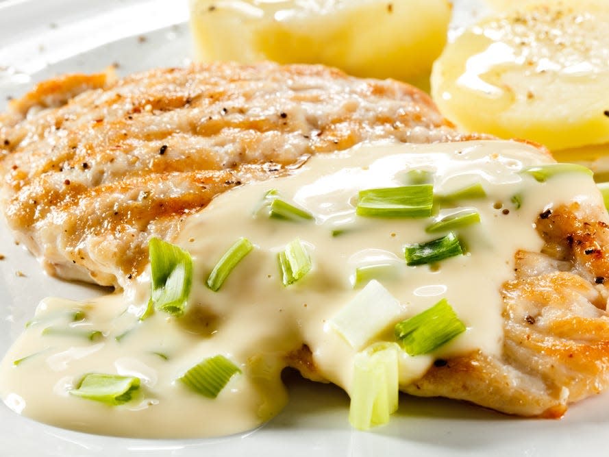 chicken with white bbq sauce on a plate