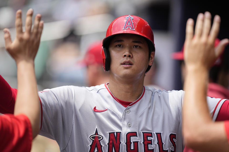 Los Angeles Angels' Shohei Ohtani (17) high fives in the dugout after scoring in the sixth inning of a baseball game against the Atlanta Braves, Wednesday, Aug. 2, 2023, in Atlanta. (AP Photo/Brynn Anderson)