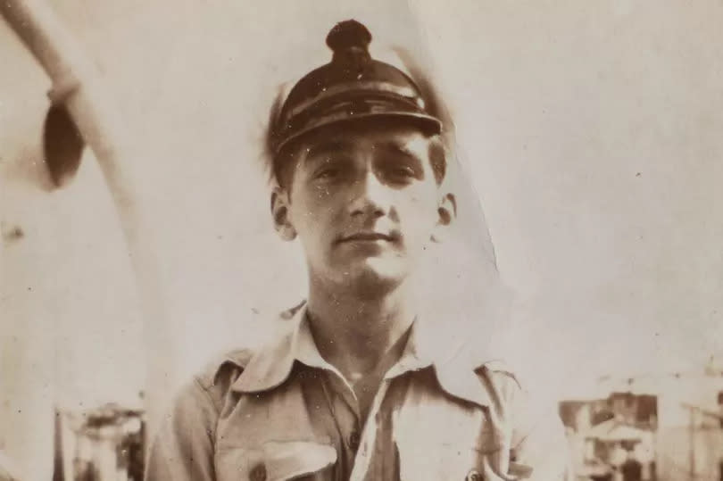 Norman Powell, D-Day veteran, pictured in 1945 on a boat in Navy clothing with white hat on