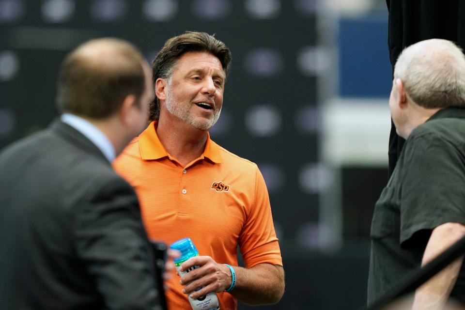 Oklahoma State head football coach Mike Gundy shares a laugh before speaking at the NCAA college football Big 12 media days in Arlington, Texas, Wednesday, July 12, 2023. (AP Photo/LM Otero)