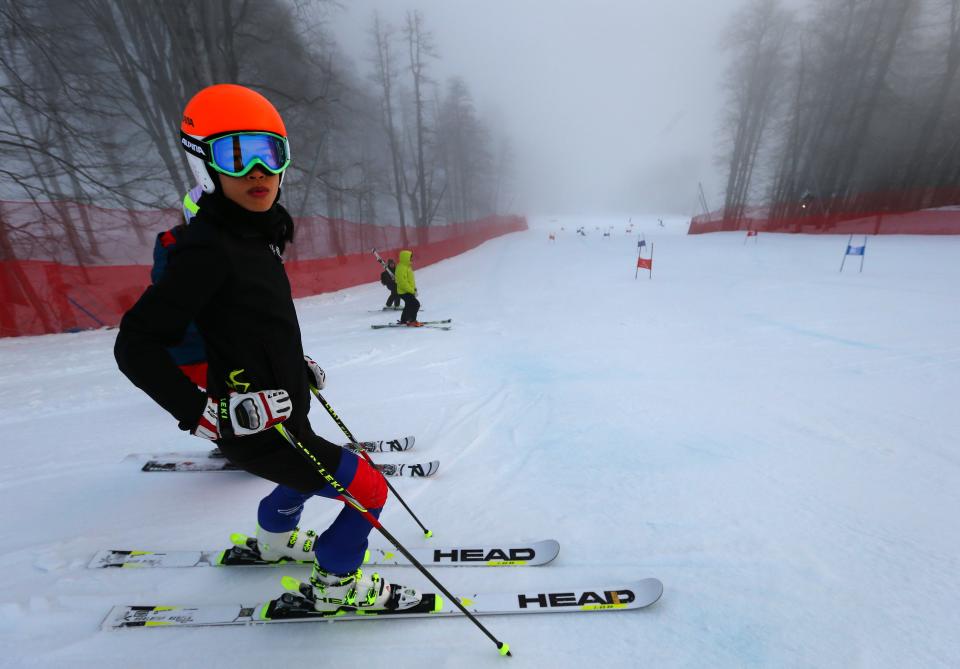 Former musician Vanessa-Mae, who will compete for Thailand as alpine skier Vanessa Vanakorn stands on the alpine skiing training slopes at the Sochi 2014 Winter Olympics, Monday, Feb. 17, 2014, in Krasnaya Polyana, Russia. (AP Photo/Alessandro Trovati)