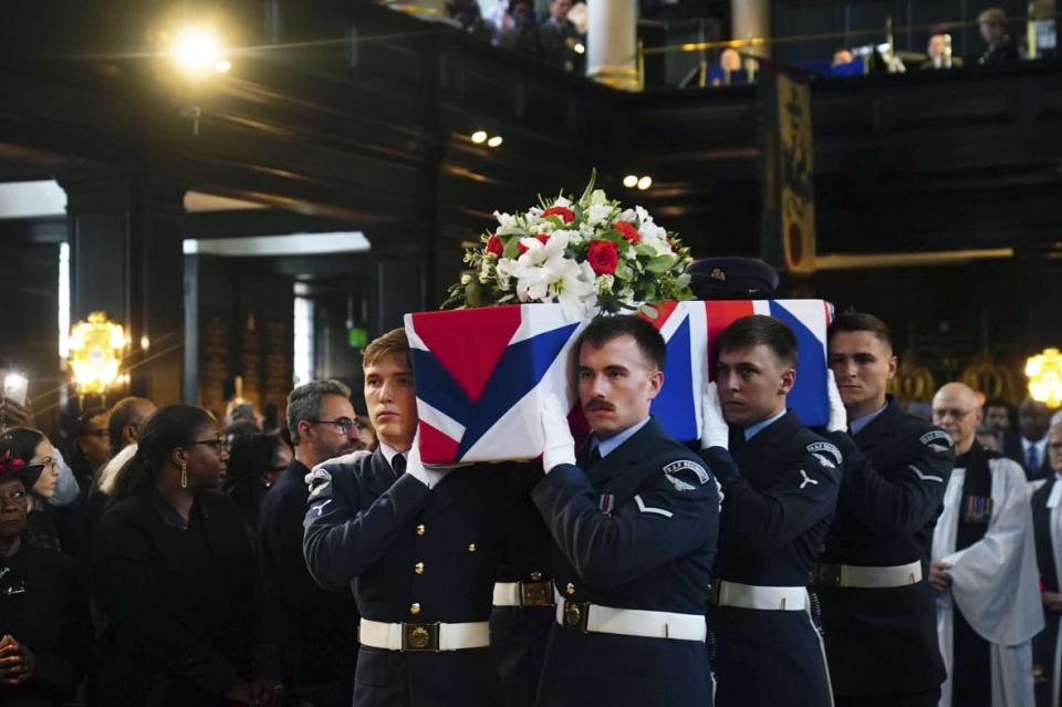 People gather for the funeral of former RAF Sergeant Peter Brown, originally from Jamaica, at St Clement Danes Church, in London, Thursday, May 25, 2023. (Photo by Victoria Jones/PA via AP)