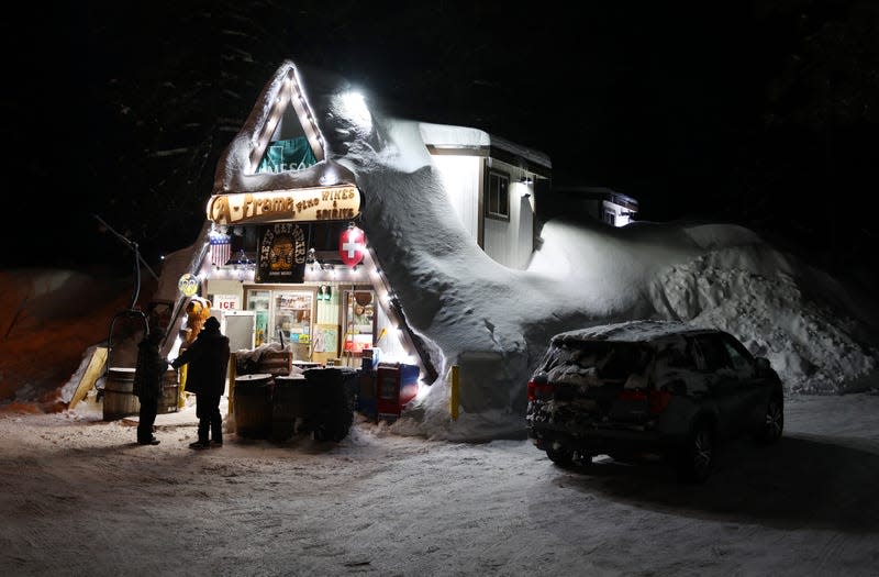 People gather at a snow-covered wine store in Mammoth Lakes, CA.