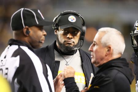 Dec 30, 2018; Pittsburgh, PA, USA; Pittsburgh Steelers head coach Mike Tomlin (center) listens to side judge Eugene Hall (left) and Steelers special teams coach Danny Smith (right) argue during the third quarter against the Cincinnati Bengals at Heinz Field. Pittsburgh won 16-13. Mandatory Credit: Charles LeClaire-USA TODAY Sports