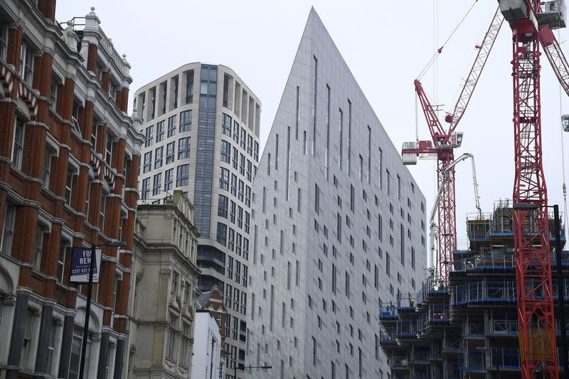 Construction work is seen amongst residential and commercial buildings in east London