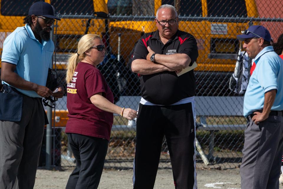 Coaches from Durfee and Case softball teams meet with the umpires before a game earlier this season. Local athletic directors have been scrambling to reassign games as they deal with a shortage of officials this season.