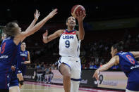 United States' A'ja Wilson lays up for a shot at goal past Serbia's Nevena Jovanovic, left, and Sasa Cado during their quarterfinal game at the women's Basketball World Cup in Sydney, Australia, Thursday, Sept. 29, 2022. (AP Photo/Mark Baker)