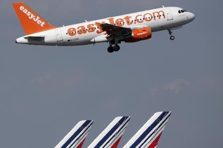 An easyJet aircraft takes-off past Air France plane tails at the Charles-de-Gaulle airport, near Paris, September 16, 2014. REUTERS/Christian Hartmann