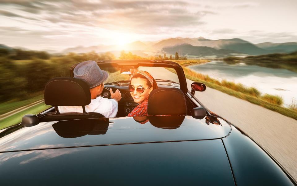 In love couple traveling by cabriolet car; - Soloviova Liudmyla/Shutterstock