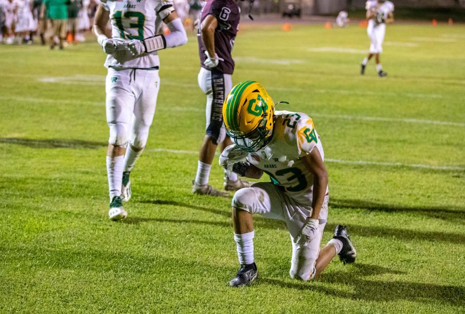 Coachella Valley's Aaron Ramirez (23) takes a knee after scoring a touchdown during the fourth quarter of their game at La Quinta High School in La Quinta, Calif., Friday, Sept. 2, 2022. 