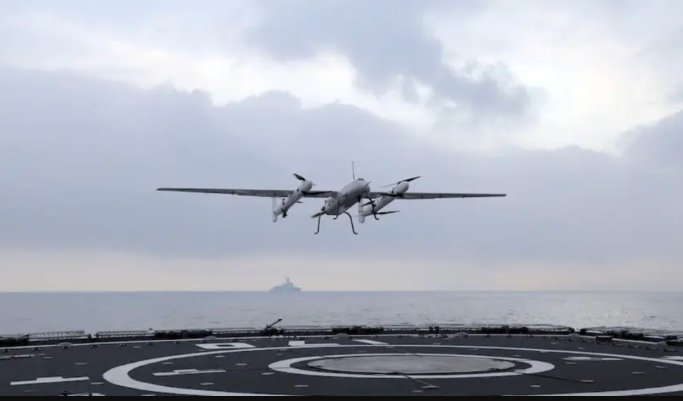 A Sea Cavalry SD-40 VTOL drone flying above the deck of a PLAN Type 052C destroyer during a test in 2019. <em>China Military Online</em>