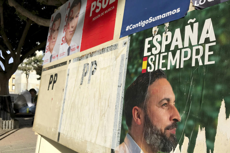 Banners of Spain's far-right Vox party candidate Santiago Abascal, right, and Spain's caretaker Prime Minister and socialist candidate Pedro Sanchez are displayed in Torre-Pacheco, Spain, Monday, Nov. 11, 2019. The farming town of Torre-Pacheco, heavily reliant on foreign workers, voted in droves for Vox, which has vowed to build walls to contain migrants and prioritize the needs of Spaniards. (AP Photo/Sergio Rodrigo)