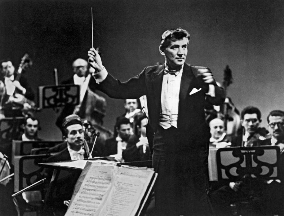 a black and white photo of leonard bernstein conducting the new york philharmonic