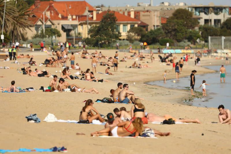 People gather together on a beach. Public gatherings have now been limited to just two people.