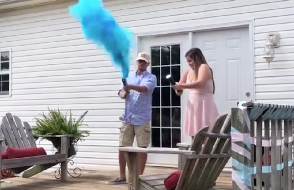 Tennessee gender reveal backfires. Blue smoke fills the air as the father-to-be twists the smoke bomb.