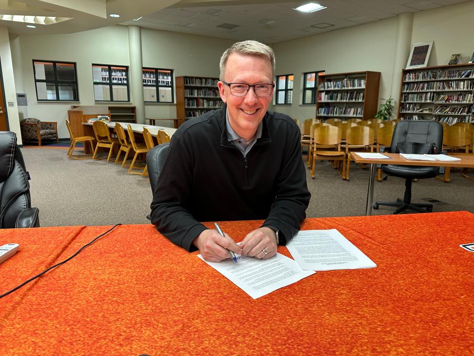 Matt Hilton signs his contract to be the new Tecumseh Public Schools superintendent on Monday, April 8, 2024, following the school board's meeting that evening.