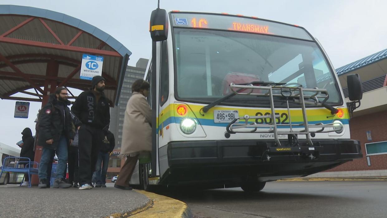 Transit Windsor riders board a bus at the downtown Windsor terminal in a February 2024 file photo.  (CBC News - image credit)