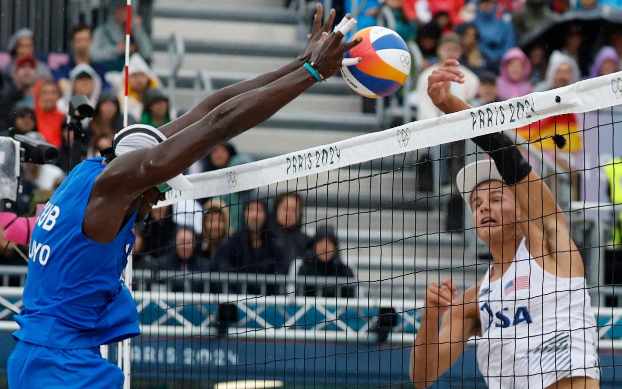 Jorge Luis Alayo Moliner, of Cuba, blocks a shot by the United States' Miles Partain in the beach volleyball at the Paris 2024 Olympic Games