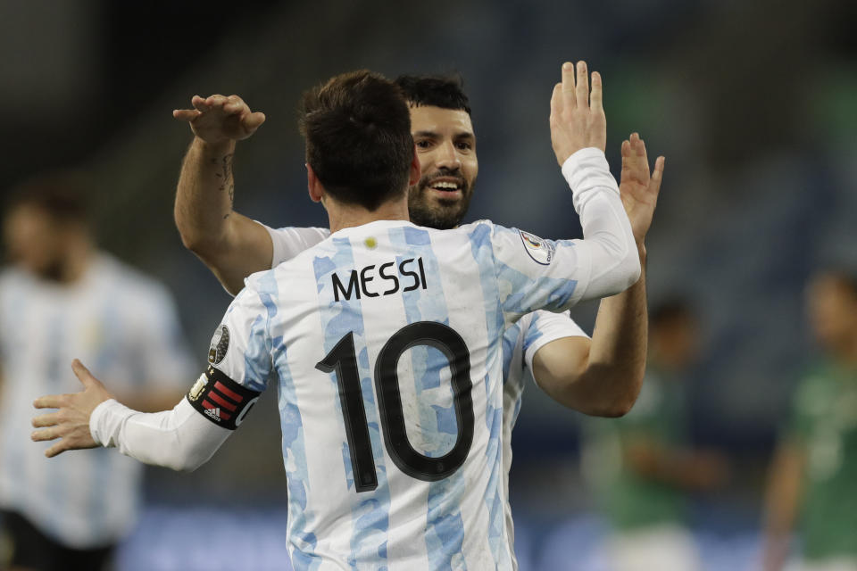 Argentina's Lionel Messi, 10, celebrates scoring his side's third goal with teammate Sergio Aguero during a Copa America soccer match against Bolivia at Arena Pantanal stadium in Cuiaba, Brazil, Monday, June 28, 2021. (AP Photo/Bruna Prado)