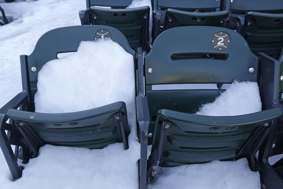 This Monday, March 17, 2014 photo taken in Chicago, shows snow covered front row seats at U.S. Cellular Field, home to the Chicago White Sox baseball team. The White Sox open their season on Monday, March 31, 2014, against the Baltimore Orioles. (AP Photo/M. Spencer Green)