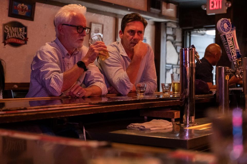 Frank Jaffe (John Slattery), left, and Fletch (Jon Hamm) have a drink in a scene from "Confess, Fletch." The scene was filmed inside Cicero's Café on Suffolk Street in Worcester.