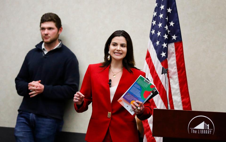 Missouri Secretary of State candidate Valentina Gomez holds up books to a crowd of children and parents at the Springfield-Greene County Library on Feb. 2 during a stop on the Brave Books reading event with authors Bethany Hamilton and Riley Gaines.