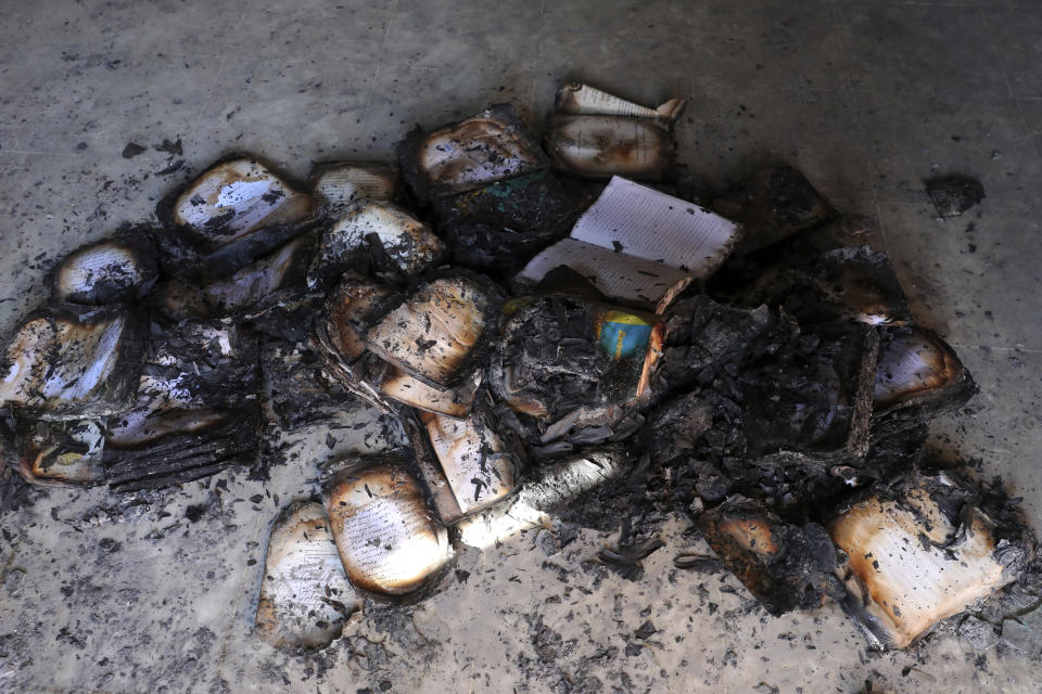 Burned books are seen inside the Kabul University after a deadly attack in Kabul, Afghanistan, Tuesday, Nov. 3, 2020. The brazen attack by gunmen who stormed the university has left many dead and wounded in the Afghan capital. The assault sparked an hours-long gun battle. (AP Photo/Rahmat Gul)