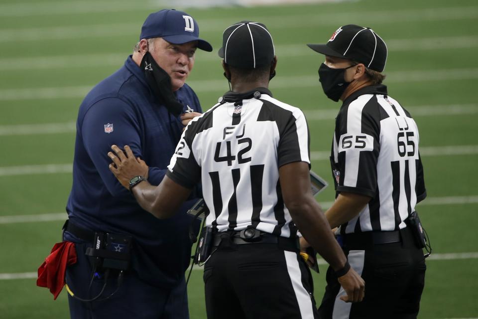 Dallas Cowboys head coach Mike McCarthy talks with referee Jeff Triplette (42) and referee Walt Coleman (65) in the first half of an NFL football game against the Atlanta Falcons in Arlington, Texas, Sunday, Sept. 20, 2020. (AP Photo/Ron Jenkins)