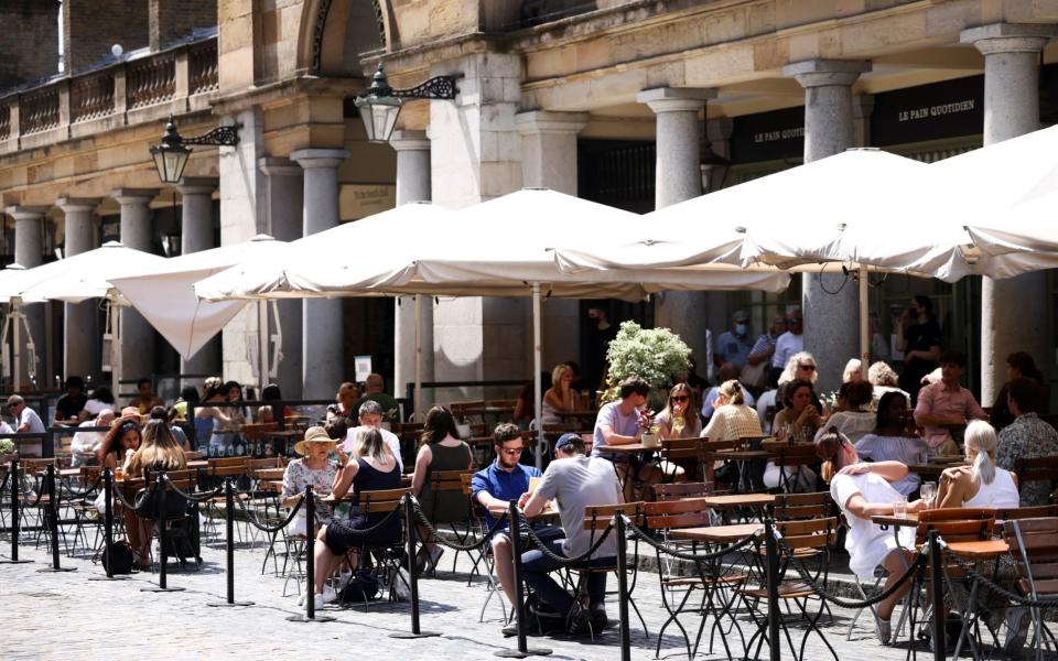 People sit in an outdoor dining area in Covent Garden, amid the coronavirus disease (COVID-19) outbreak, in London, Britain, June 15, 2021 - Reuters