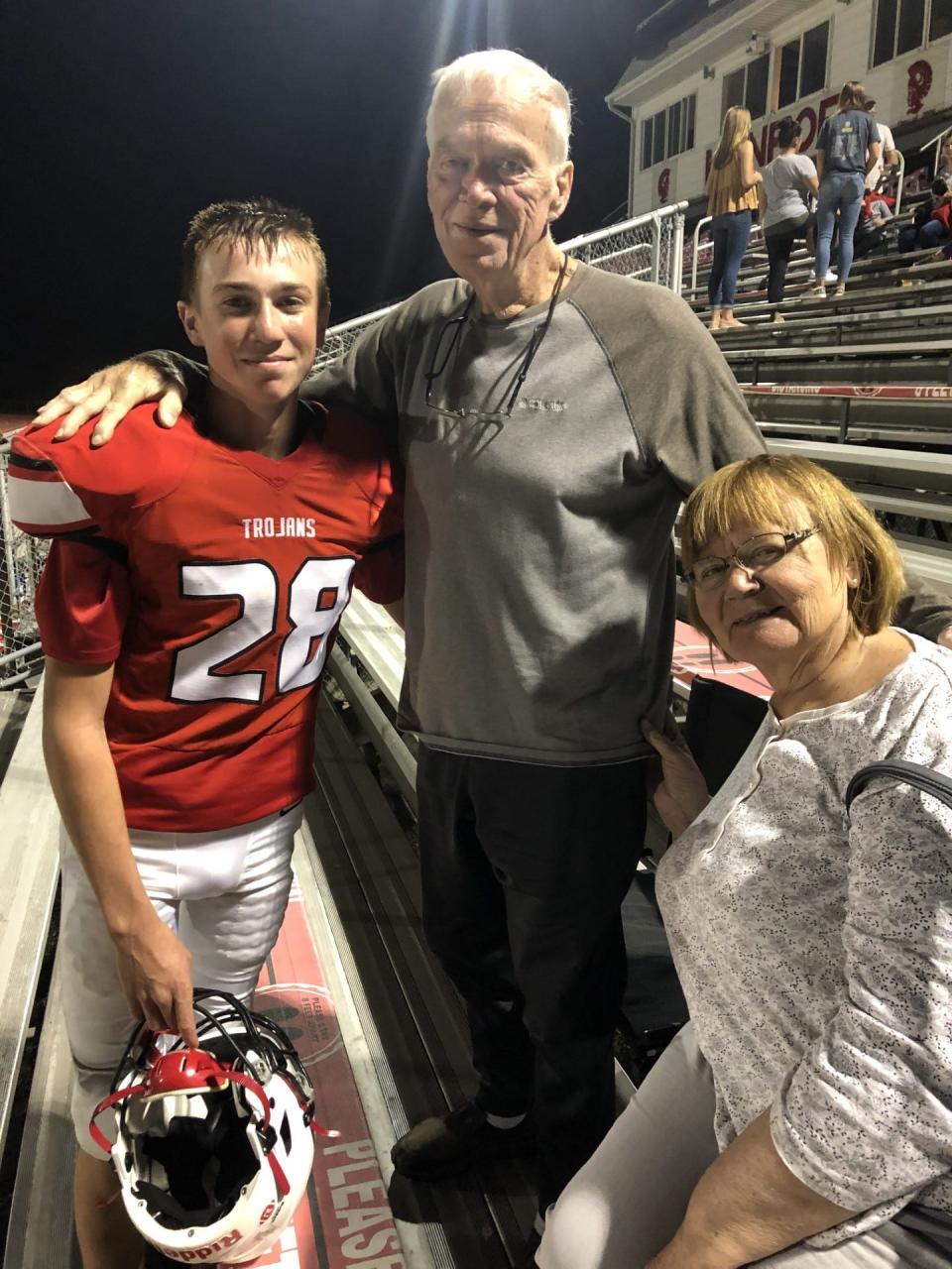 Camden Schmidt is shown at the final Monroe High School home football game of last season. He is pictured with his grandparents, Robert and Linda Kuehnlein.