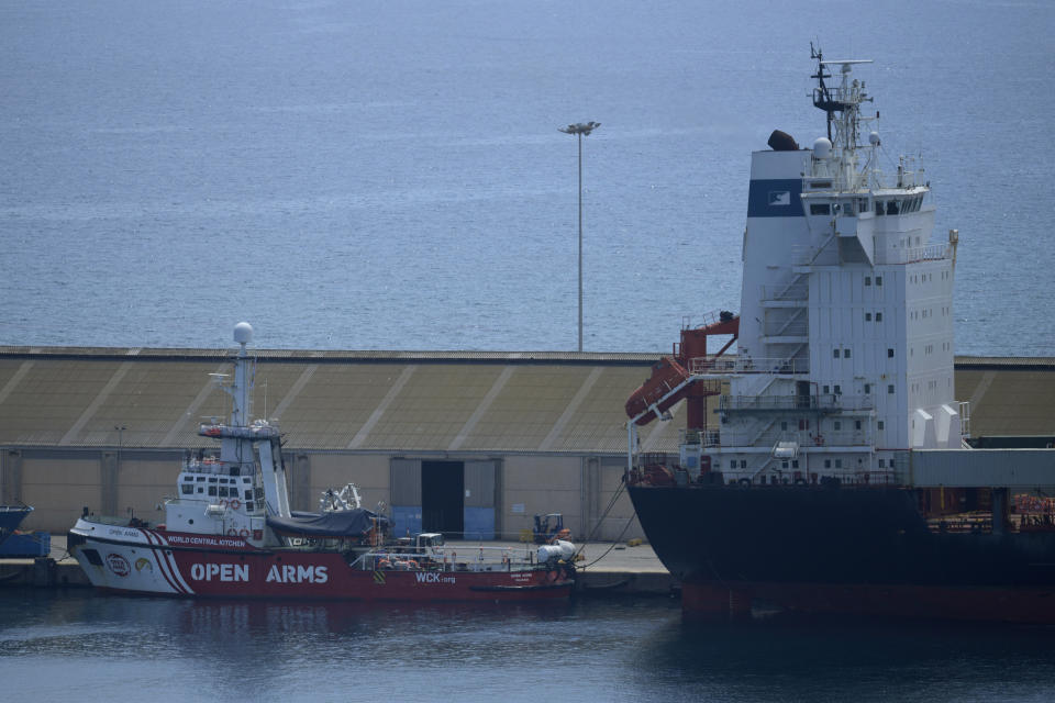 A view of the open arms ship and the container ship Sagamore, right, docked at Larnaca port, Cyprus, Wednesday, May 8, 2024, where food heading to Gaza is being loaded for eventual delivery. (AP Photo/Petros Karadjias)