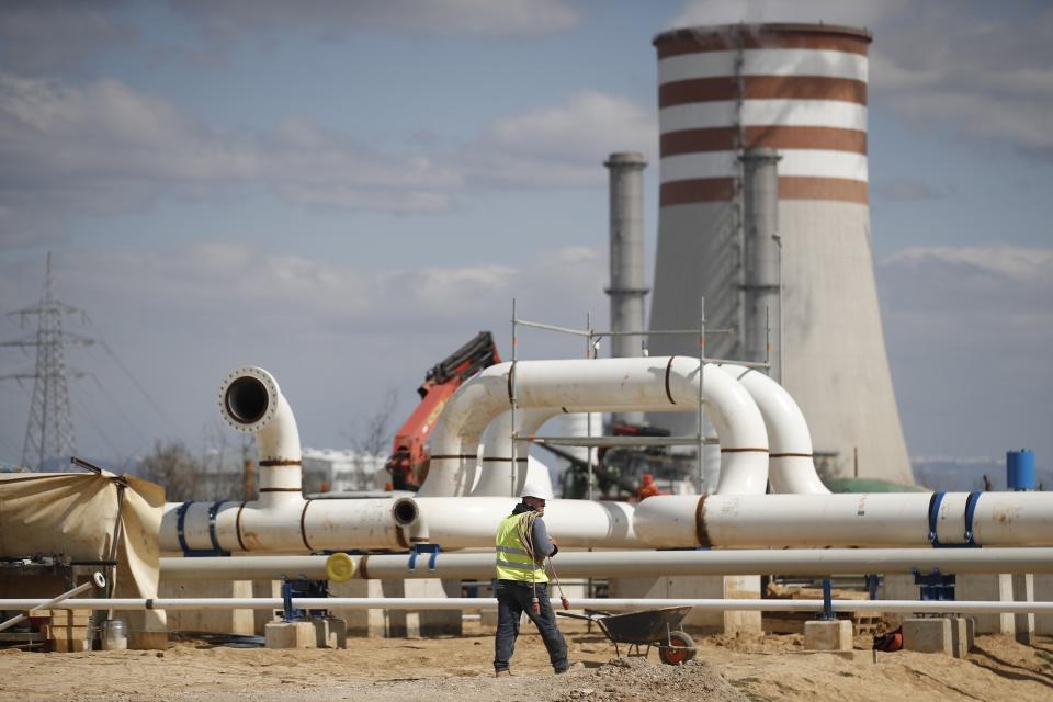 A man walks at a work site of a new pipeline near Komotini town, northern Greece, Monday, March 21, 2022. Crossing a remote border area of Greece and Bulgaria, a new pipeline nearing completion will help countries in the region dependent on Russian imports greater access to the global natural gas market.(Dimitris Tosidis/AMNA via AP)