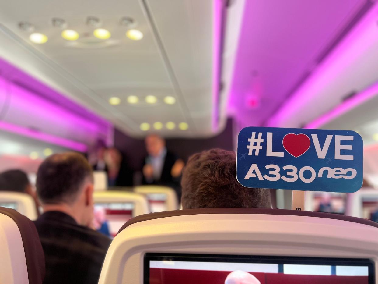 Onboard the Virgin A330neo with pink mood lighting.