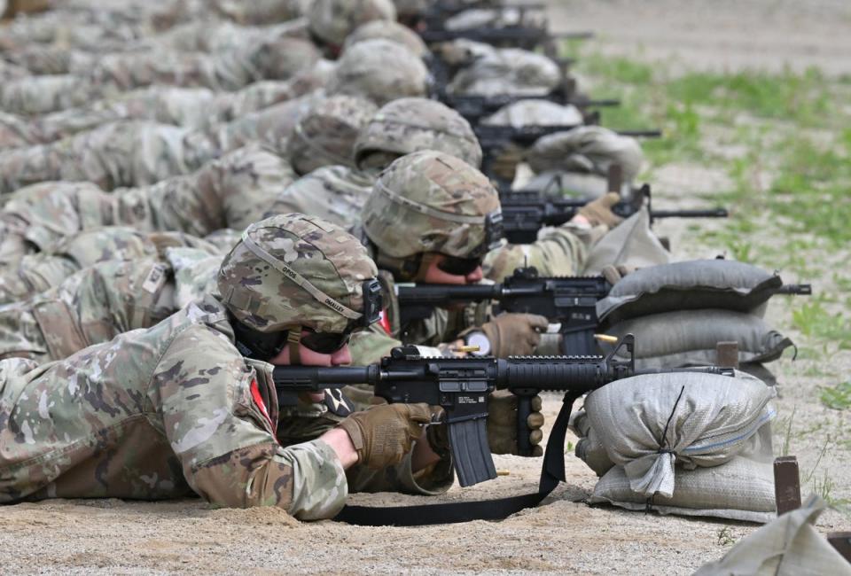 US soldiers aim their rifle at a shooting range during a stress shoot test of the Best Squad Competition conducted by the US 2nd Infantry Division and the ROK-US Combined Division at the US Army's Camp Casey in Dongducheon on May 1, 2024. (AFP via Getty Images)