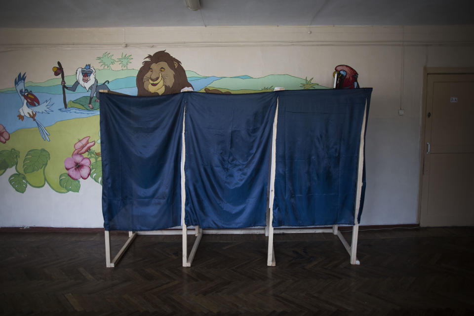 Voting booths for Sunday's referendum are seen at a polling station in Simferopol, Ukraine, Saturday, March 15, 2014. Tensions are high in the Black Sea peninsula of Crimea, where a referendum is to be held Sunday on whether to split off from Ukraine and seek annexation by Russia. (AP Photo/Manu Brabo)