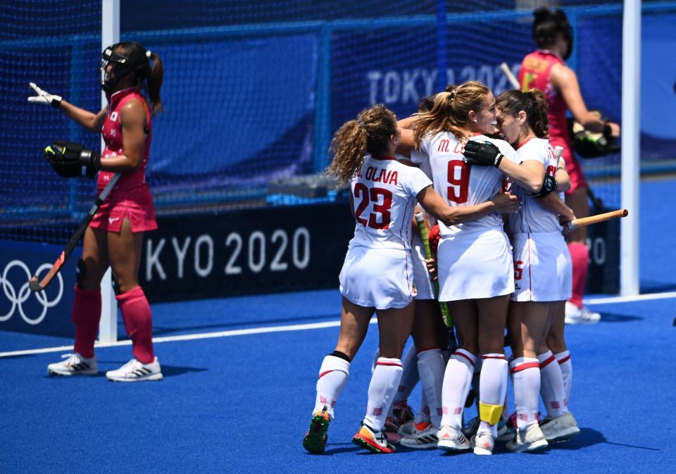 Spain's Candela Mejias (covered) celebrates with teammates after scoring against Japan during their women's pool B match of the Tokyo 2020 Olympic Games field hockey competition, at the Oi Hockey Stadium in Tokyo on July 31, 2021. (Photo by MARTIN BUREAU / AFP) (Photo by MARTIN BUREAU/AFP via Getty Images)