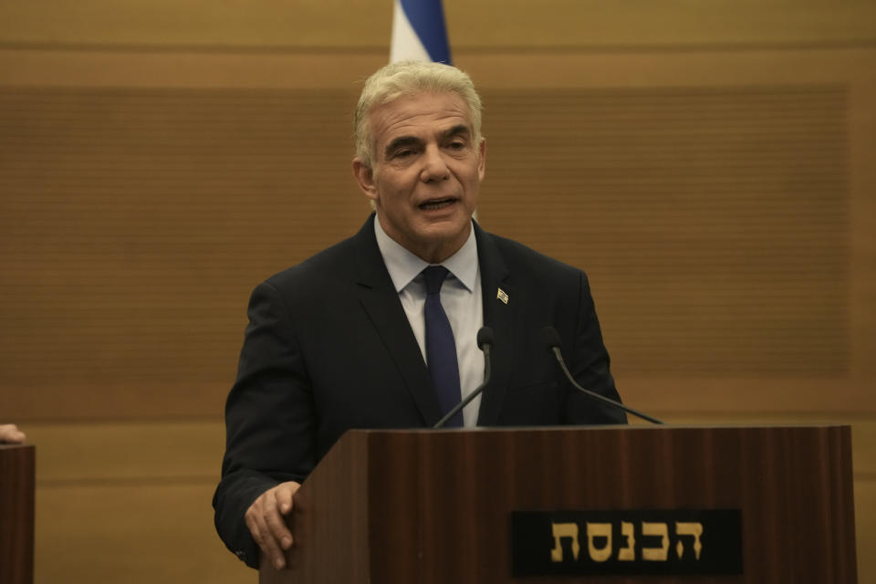 Israeli Foreign Minister Yair Lapid speaks during a joint statement with Prime Minister Naftali Bennett, at the Knesset, Israel's parliament, in Jerusalem, Monday, June 20, 2022. Bennett's office announced Monday, that his weakened coalition will be disbanded and the country will head to new elections. Bennett and his main coalition partner, Yair Lapid, decided to present a vote to dissolve parliament in the coming days, Bennett's office said. Lapid is then to serve as caretaker prime minister. The election, expected in the fall, would be Israel's fifth in three years. (AP Photo/Maya Alleruzzo)