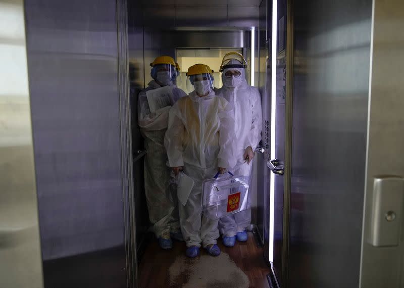 Members of an electoral commission visit a regional hospital during a nationwide vote on constitutional reforms in Tver