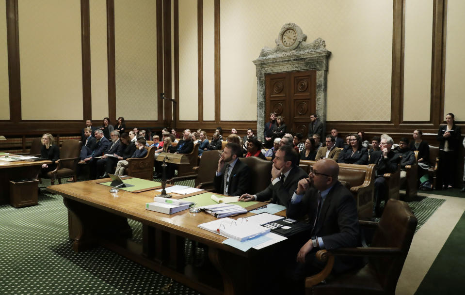 Attorneys and audience members listen Tuesday, Jan. 22, 2019, during a Washington Supreme Court hearing in Olympia, Wash., on a lawsuit addressing the constitutional freedom of electors to vote for any candidate for president, not just the nominee of their party. (AP Photo/Ted S. Warren)