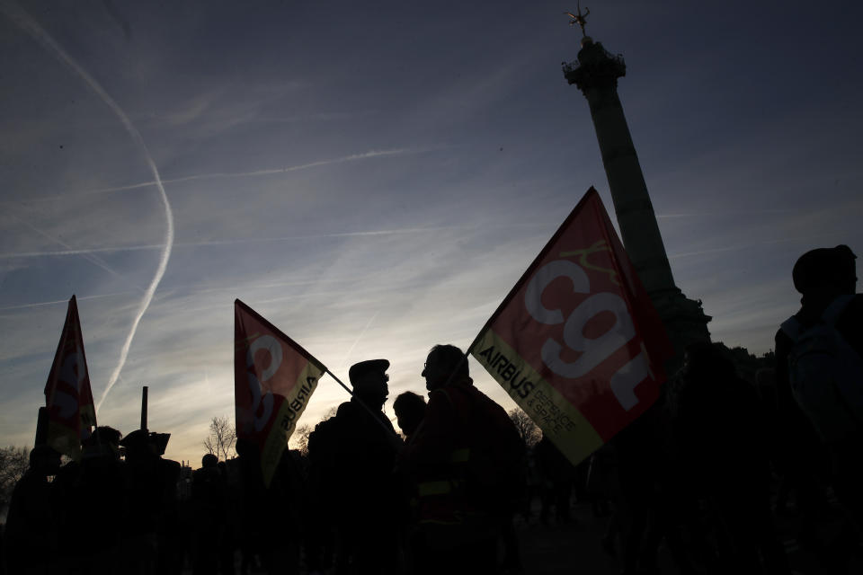 Protesters of Aibus unions with banners of CGT union attend a demonstration at Bastille square in Paris, Saturday, Jan. 11, 2020. The French government and labor unions appeared far from reaching any compromise deal Friday in talks over a planned pension overhaul, with strikes and protests grinding on. (AP Photo/Francois Mori)