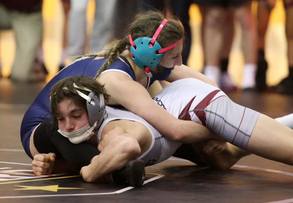 Alyssa Mahan (top) wrestles in the 2023 DIAA Division II dual meet team championship.